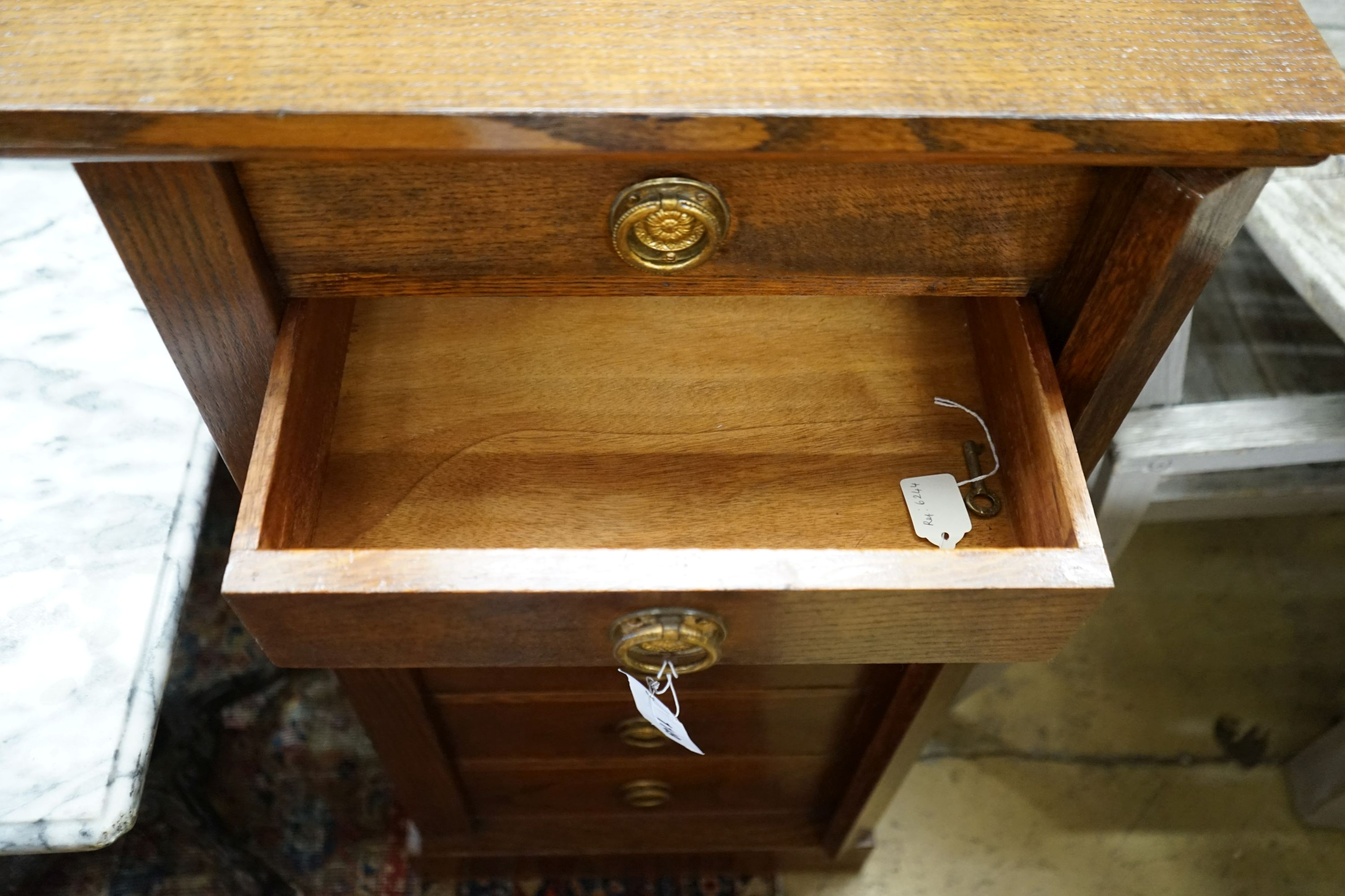 A 1920's oak Wellington chest, width 51cm depth 34cm height 105cm